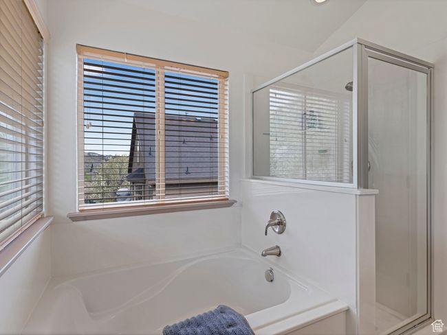 Full bathroom featuring a shower stall and a garden tub | Image 21