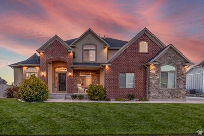 Front of home with stone, brick, & stucco. | Image 3