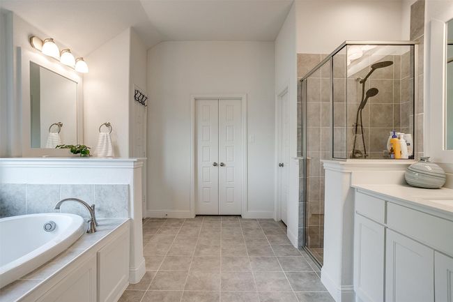 Bathroom featuring a shower stall, vanity, a garden tub, and tile patterned floors | Image 22