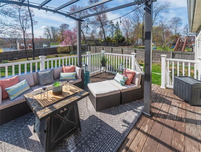 Wooden terrace with an outdoor living space, a lawn, and a fenced backyard | Image 23