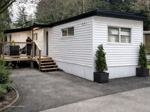 Rear view of property with a wooden deck | Card Image