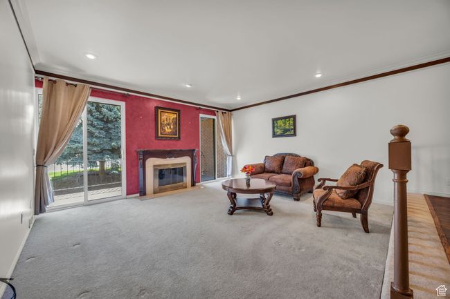 Carpeted living area featuring recessed lighting, a high end fireplace, baseboards, and ornamental molding | Image 4