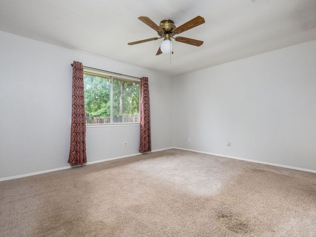 Spare room with carpet and a ceiling fan | Image 13