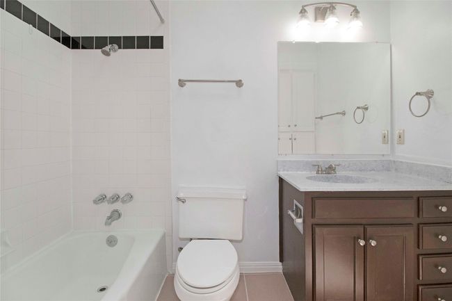 Secondary Bath with new towel racks, new mirror, and linen closet. | Image 31