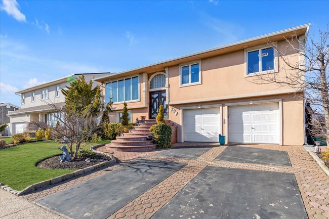 Raised ranch featuring aphalt driveway, a garage, a front yard, and stucco siding | Image 20