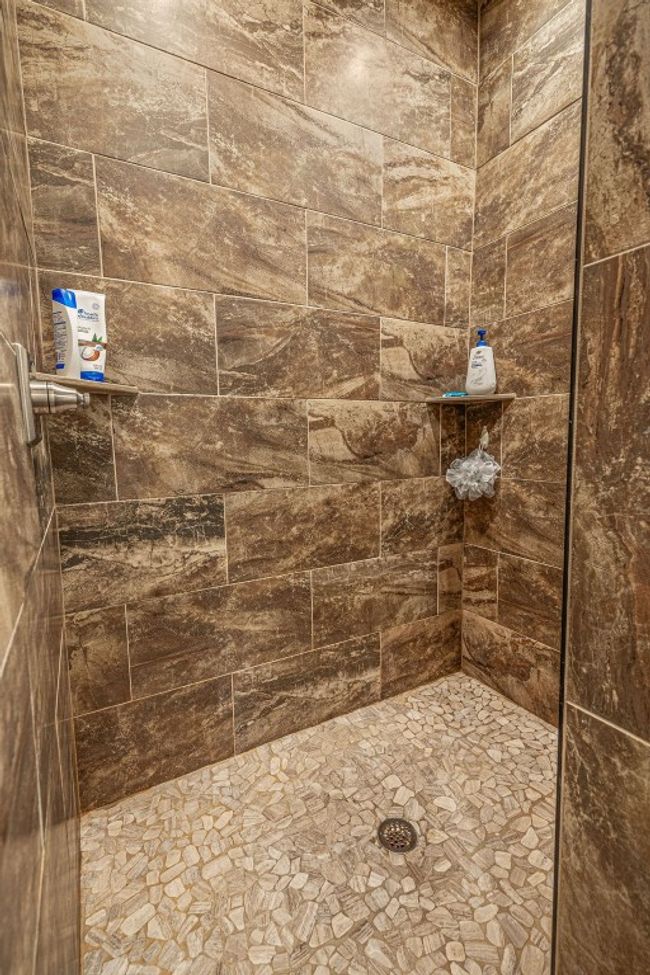 Full bathroom featuring tiled shower | Image 26