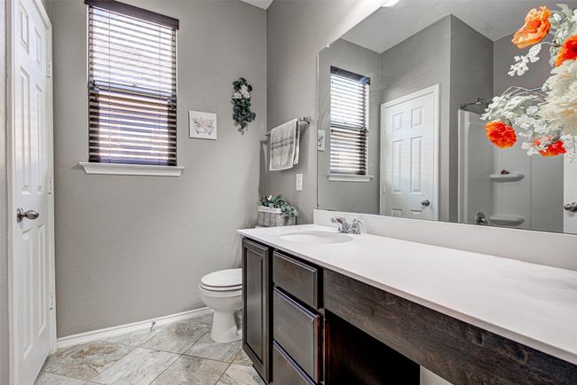 Full bathroom with walk in shower, baseboards, vanity, and toilet | Image 18