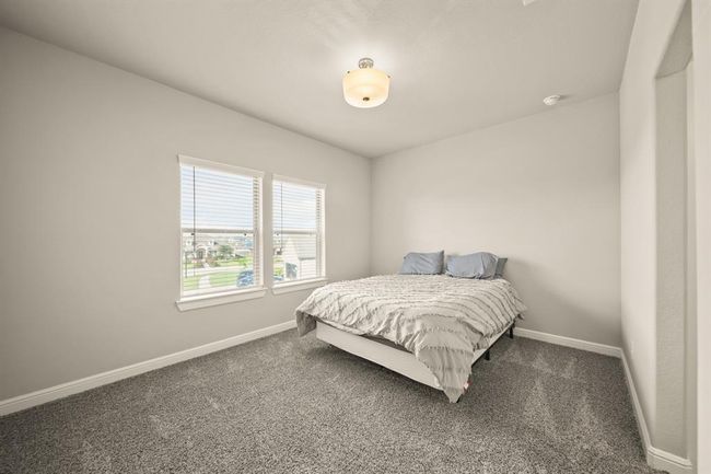 Another view of the secondary bedroom showcasing convenient access to shared bathroom and hallway. | Image 33