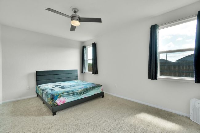 Carpeted bedroom featuring baseboards and a ceiling fan | Image 16
