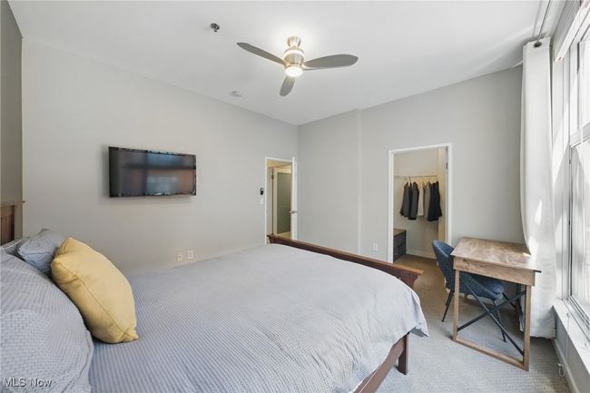 Bedroom featuring a walk in closet, carpet, a closet, and a ceiling fan | Image 26