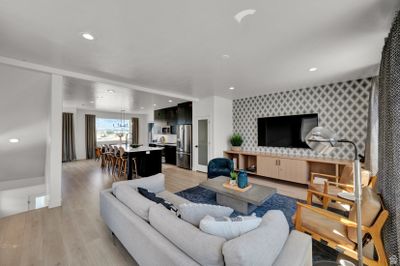 Living room featuring an inviting chandelier and light hardwood / wood-style flooring | Image 2