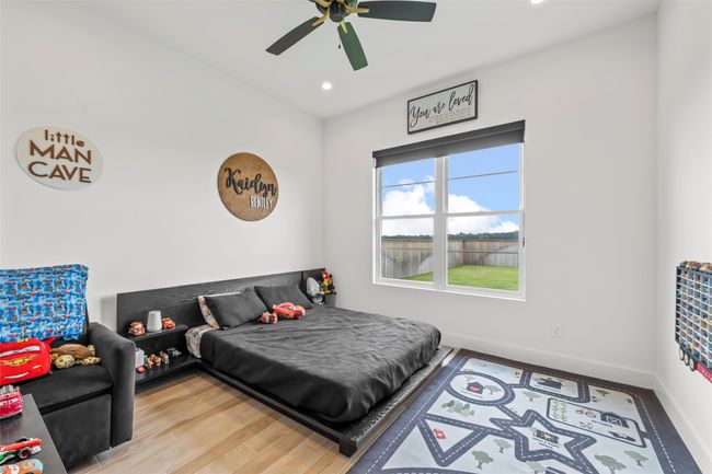 Bedroom featuring baseboards, recessed lighting, wood finished floors, and a ceiling fan | Image 30