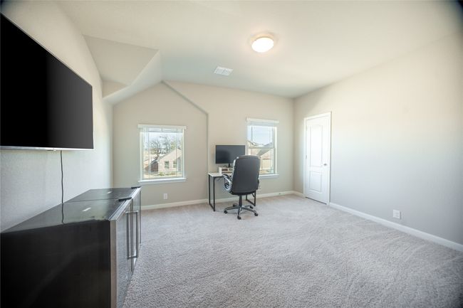 Home office featuring light colored carpet and lofted ceiling | Image 26