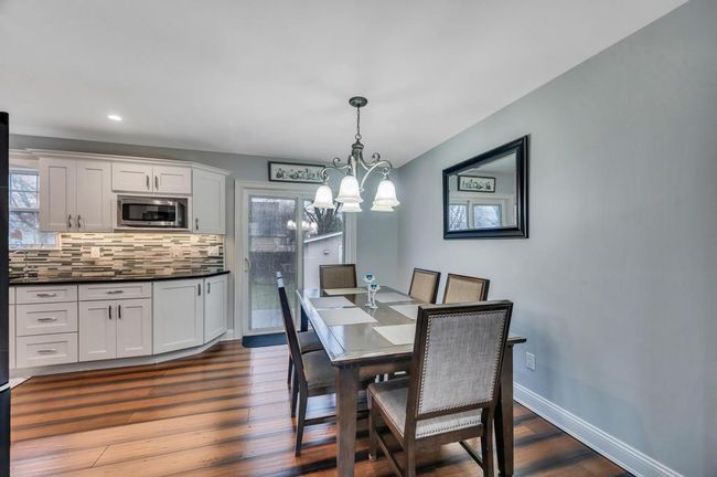 Dining room featuring plenty of natural light, baseboards, and dark wood finished floors | Image 7