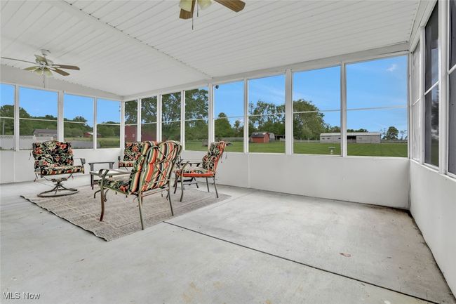 Sunroom with a ceiling fan | Image 24