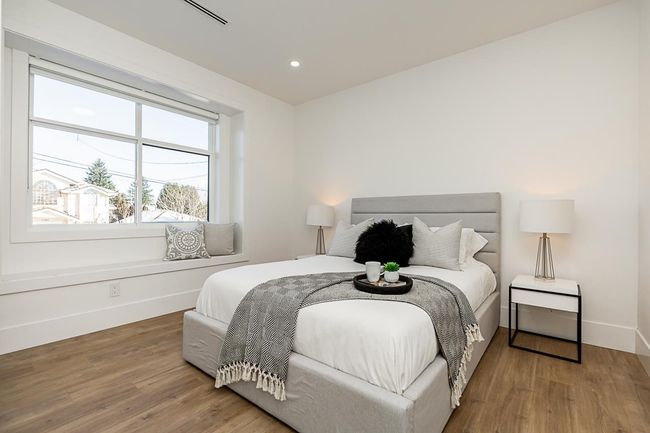 Bedroom with baseboards, multiple windows, wood finished floors, and recessed lighting | Image 11