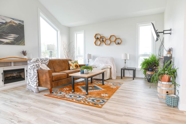 Living room featuring wood finished floors, plenty of natural light, and a fireplace | Image 19