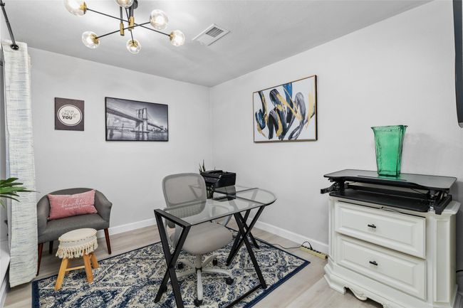 Office space with light wood-type flooring, visible vents, a notable chandelier, and baseboards | Image 5
