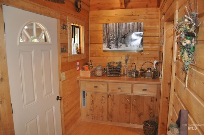 Entryway with wood walls, healthy amount of natural light, and light wood finished floors | Image 11