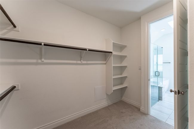 Walk in closet with light carpet | Image 29