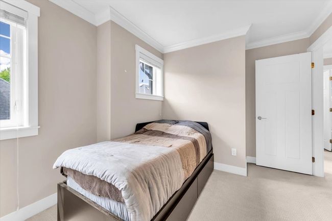 Bedroom with crown molding and light carpet | Image 16