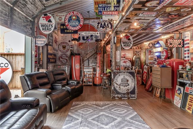 mancave with overhead door opens out to carport/patio area | Image 13