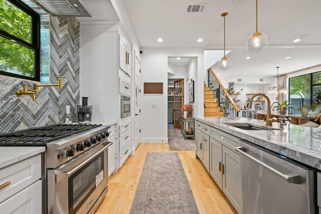 View looking towards the hall that leads to powder bath, laundry room and garage. | Image 10