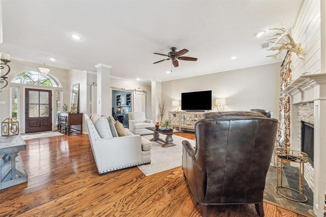 The spacious family room offers an inviting atmosphere with elegant design and soothing neutral tones throughout the home. | Image 10