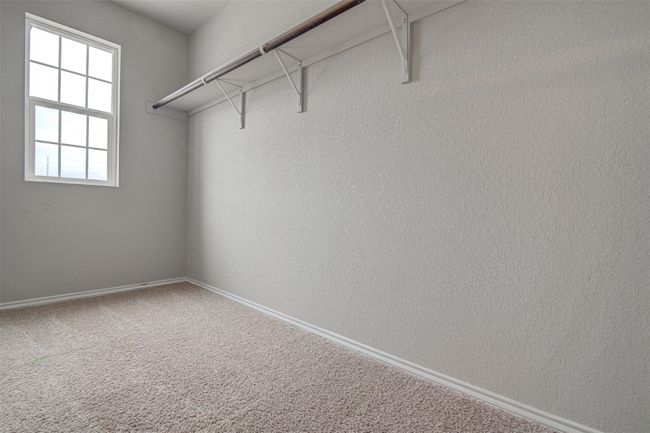 Walk in closet with carpet floors | Image 26