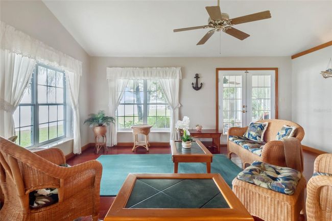 Great Room features French Doors leading onto the Screened-in Lanai | Image 7
