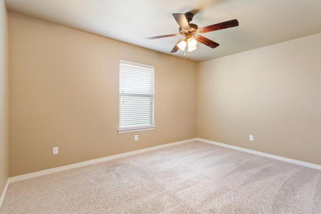 Spare room featuring baseboards, carpet floors, and ceiling fan | Image 29
