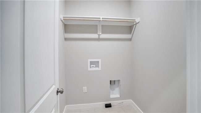 Laundry room with baseboards, hookup for a washing machine, tile patterned flooring, and electric dryer hookup | Image 16