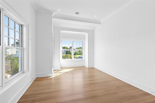 Empty room featuring crown molding, light wood-type flooring, and baseboards | Image 35
