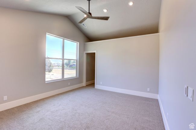 Unfurnished room with ceiling fan, light carpet, lofted ceiling, and recessed lighting | Image 26