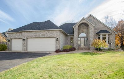 Front formal living room with vaulted ceilings and open flow to formal dining room. | Image 1