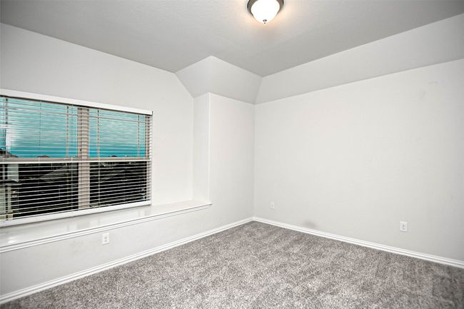 Empty room with baseboards, lofted ceiling, and carpet | Image 28