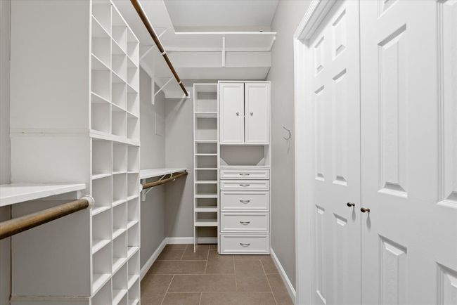 The second side of the primary closet has extra storage for your extensive accessory collection! | Image 21