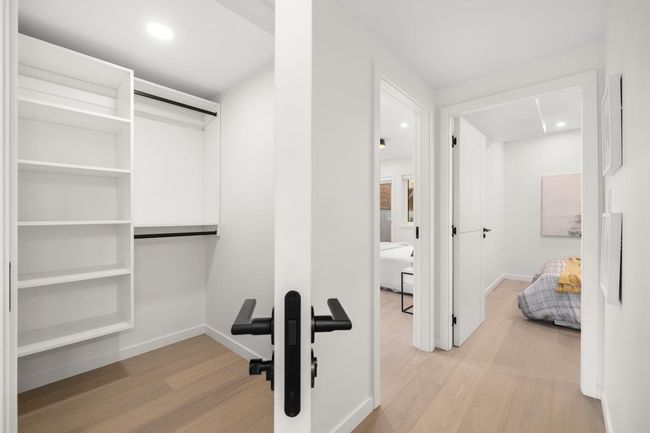 Spacious closet featuring light wood-style floors | Image 17