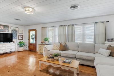 Living room with crown molding, wooden ceiling, and hardwood / wood-style floors | Image 3