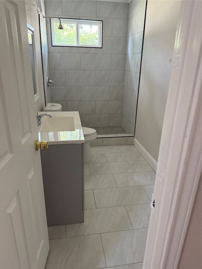 Bathroom with vanity and tiled shower | Image 8