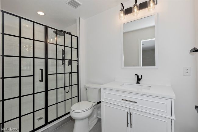 Bathroom with tile flooring, oversized vanity, and toilet | Image 50