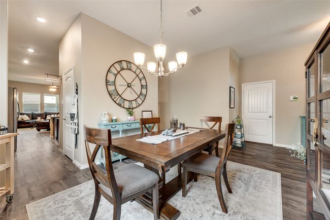 Dining space with a chandelier, wood finished floors, and recessed lighting | Image 8
