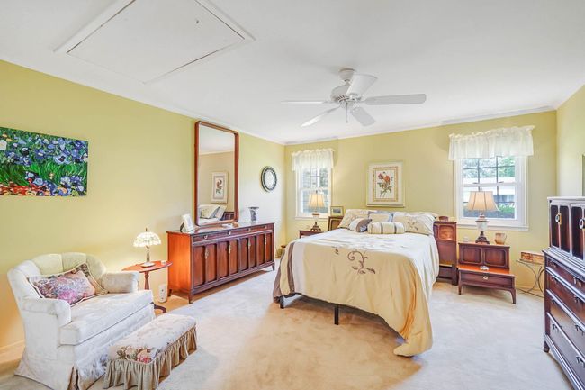 Bedroom featuring attic access, light carpet, ornamental molding, and ceiling fan | Image 14