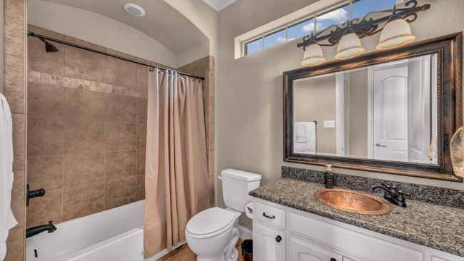 Full bathroom with vanity, shower / bathtub combination with curtain, and toilet | Image 29