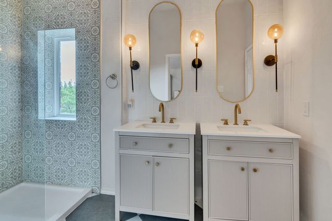 Full bathroom with two vanities and tiled shower | Image 23