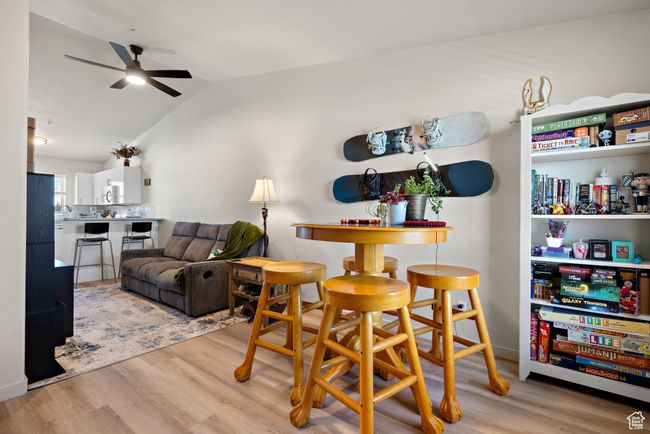Dining space with ceiling fan, wood finished floors, and lofted ceiling | Image 10