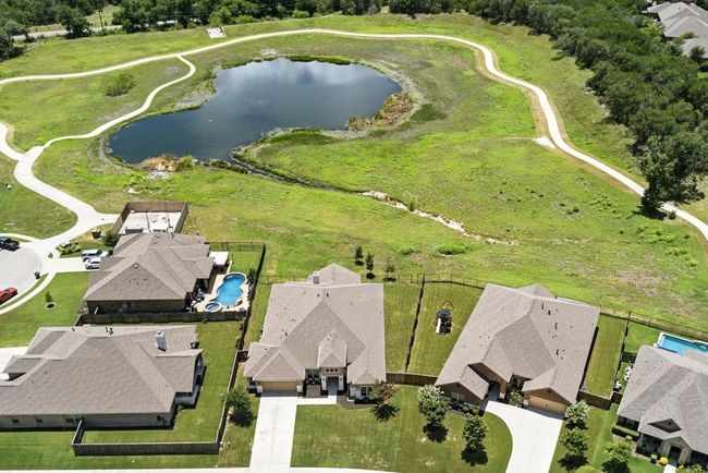 Aerial perspective of suburban area featuring a nearby body of water | Image 34