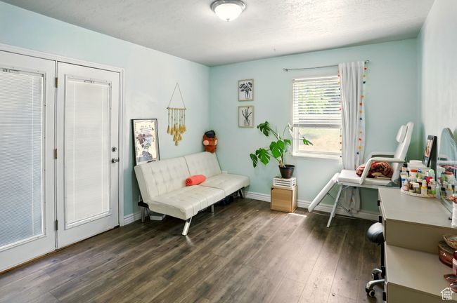 Living area with dark wood finished floors and baseboards | Image 11