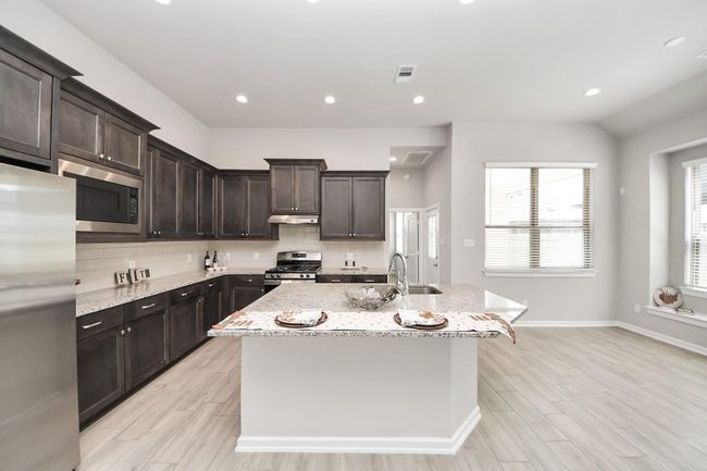 Plenty of cabinet storage and modern backsplash for a stylish look | Image 17