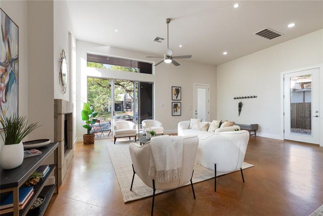 Living room with recessed lighting, a fireplace, a ceiling fan, and baseboards | Image 5